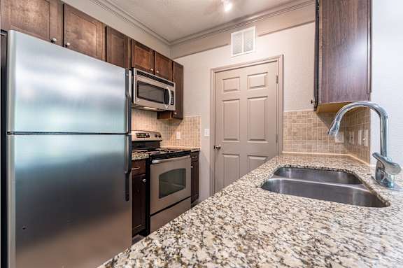 Kitchen with Granite Countertops at Waterstone at Cinco Ranch Apartments, Texas