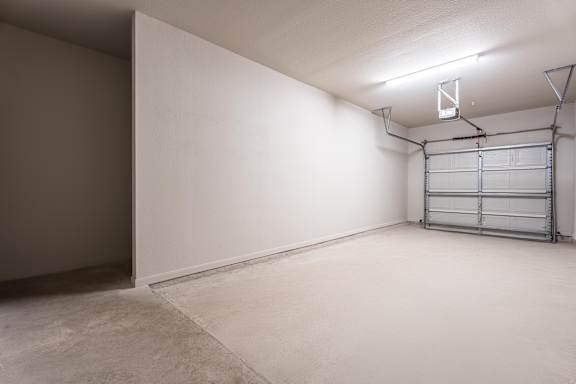 A room with a white wall and a metal shelf  at Waterstone at Cinco Ranch Apartments, Katy