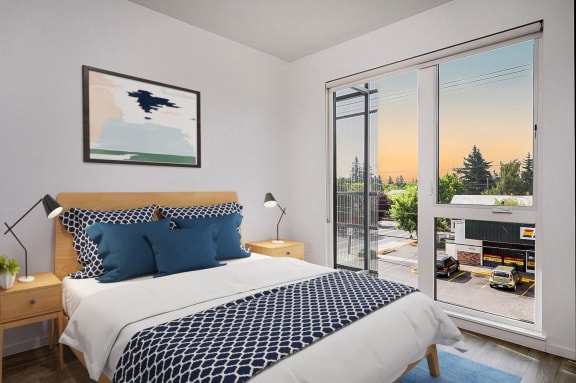 a bedroom with a bed and a large glass door to a balcony