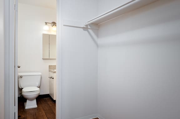 A white toilet is in a small bathroom.