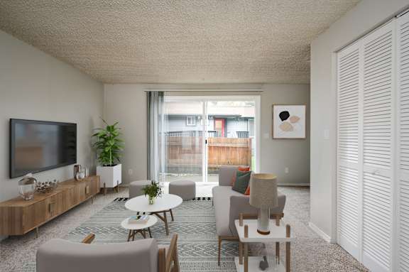 A living room with a flat screen TV on the wall.