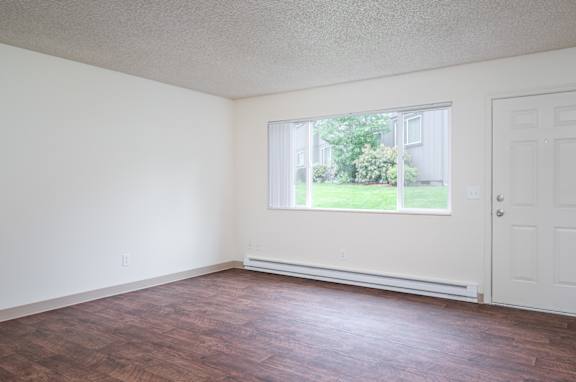 Empty room with a window and a door.