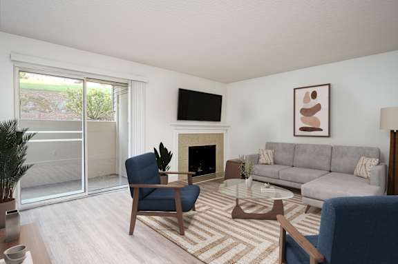 A living room with a fireplace and a television on the wall.