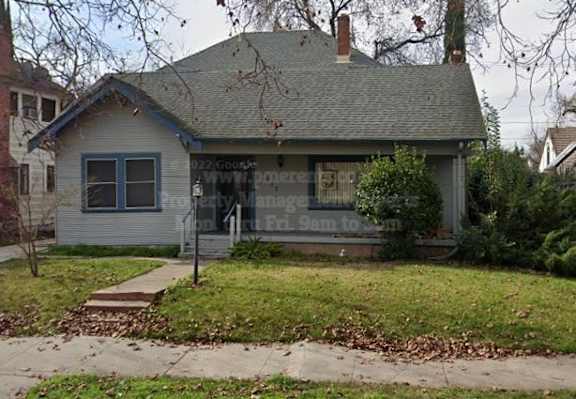 A house with a sign that says "DZJ Gooch's" on it.