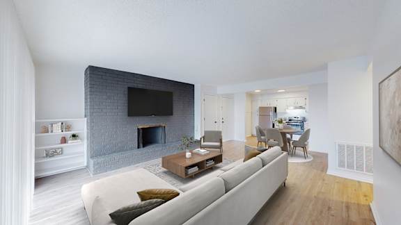 Floor Plan  A modern living room with a grey couch and a fireplace.