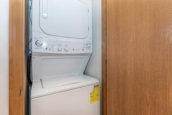 A white washing machine with a yellow sticker on the door.