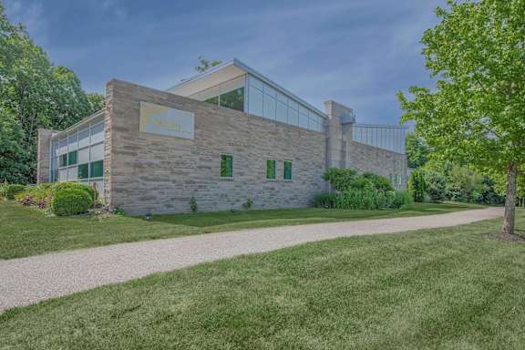 A modern building with a stone facade and large windows.