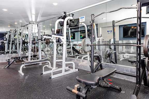 A gym with a variety of equipment including a leg press machine.