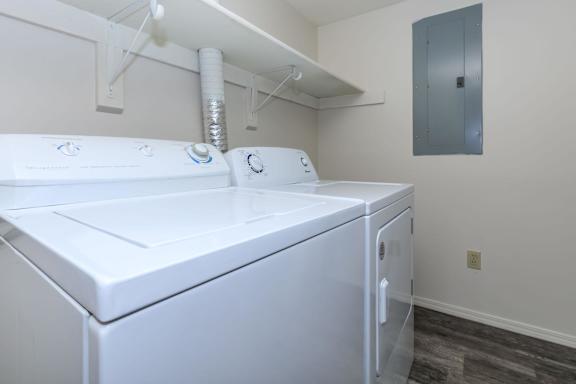 A white washing machine and dryer in a small laundry room.
