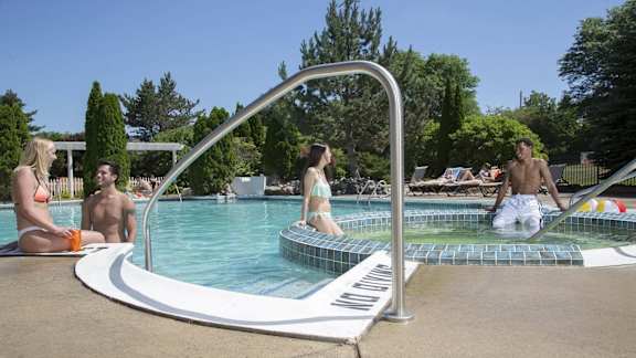 People are enjoying their time in the pool.