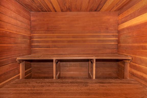 A wooden bench sits in the middle of a wooden room.