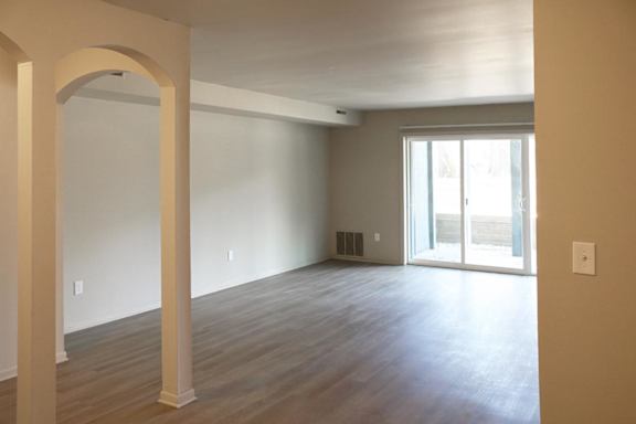 A room with a sliding glass door and a window.