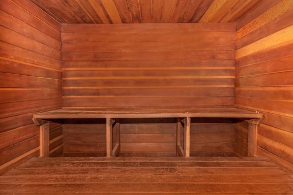 A wooden bench sits in the middle of a wooden room.