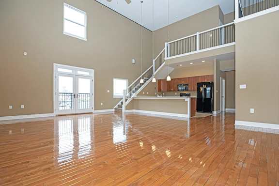 A spacious living room with a staircase leading to the upper floor.