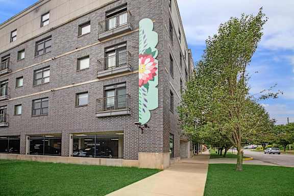 A large building with a large flower painted on the side.