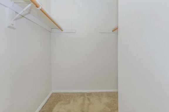 A small, empty room with a carpeted floor and white walls.
