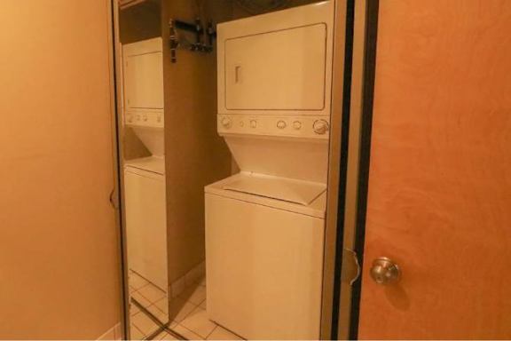 A white washer and dryer in a small laundry room.
