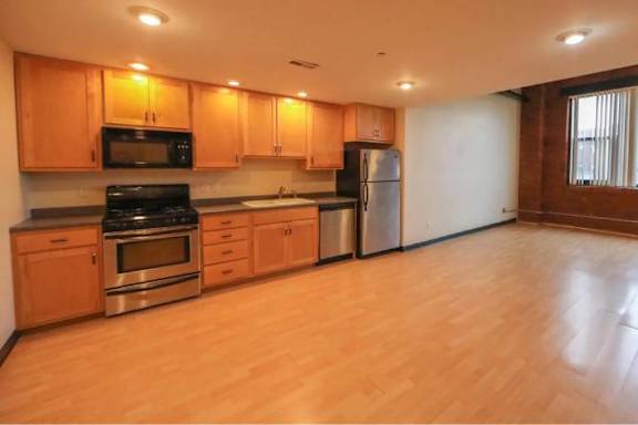 A kitchen with wooden cabinets and stainless steel appliances.