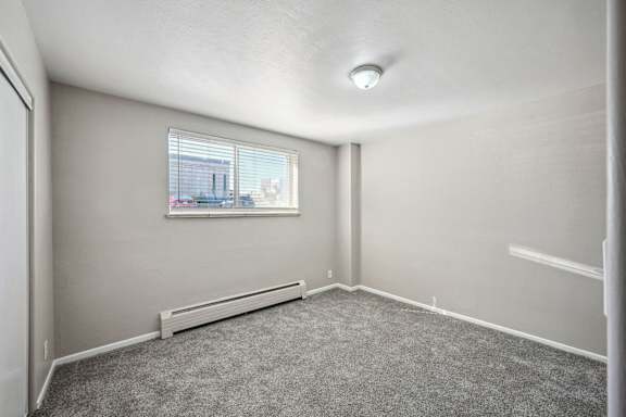 an empty living room with a window and carpet at Park at Fitzsimons Apartments, Colorado, 80011