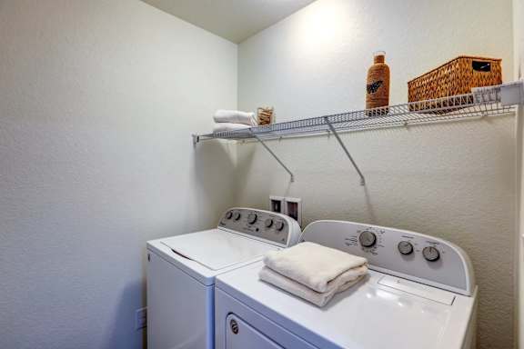 Laundry room with a washer and dryer at Enclave Apartments, Henderson, 80640