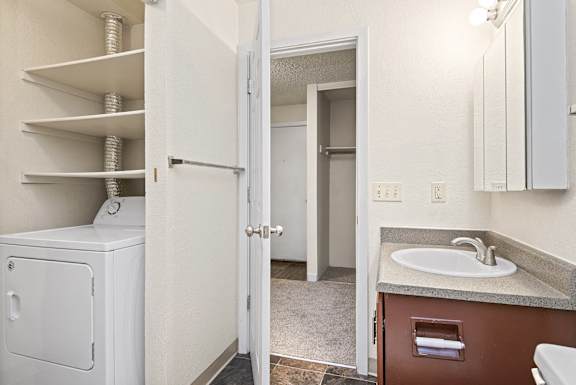 A white washer and dryer are in a small laundry room. at Brookstone, SeaTac, WA, 98198