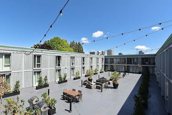 a courtyard with tables and benches on a roof of a building at Cosmopolitan, Washington