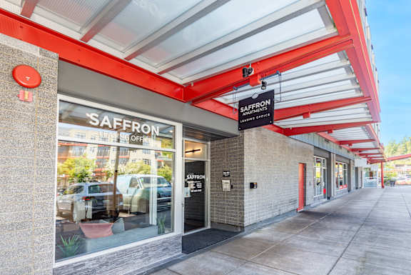 The exterior of a Saffron store with a red awning.