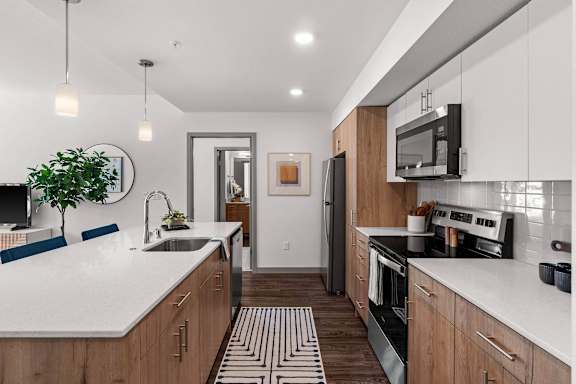 A modern kitchen with wooden cabinets and a white countertop.