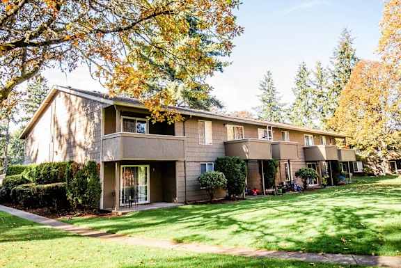 the view of an apartment building with a lawn and trees at Bellamy Park Apartments , Washington 98498