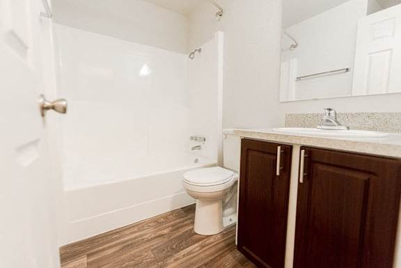 a bathroom with a toilet and a sink at Bellamy Park Apartments , Lakewood