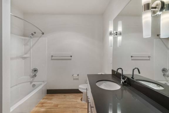 A bathroom with a white tub and sink.