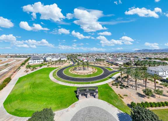 A park with a circular walkway and a monument in the middle.