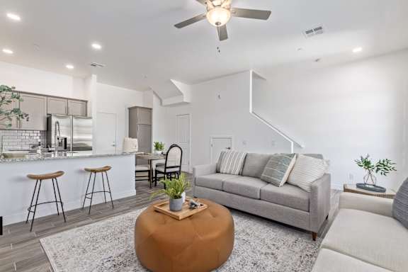 A modern living room with a grey sofa and a wooden coffee table.