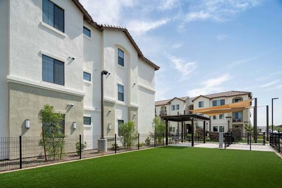 A row of houses with a green lawn in front.