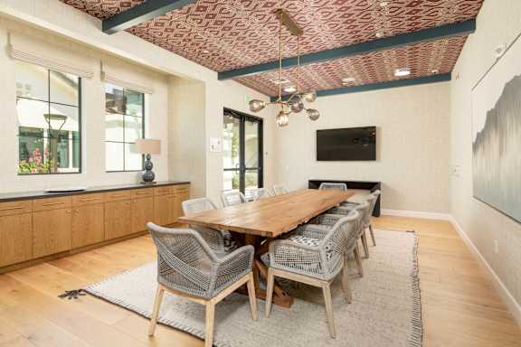 A dining room with a wooden table and chairs.
