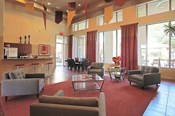 A large room with a red carpet and furniture.