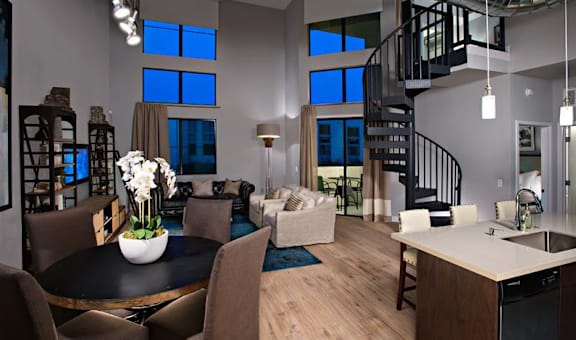 A modern kitchen with a dining table and chairs.