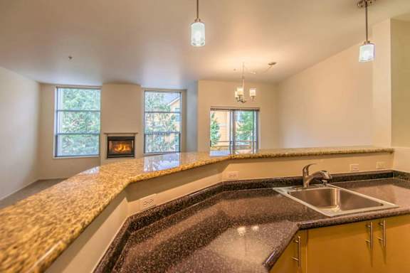 A kitchen with a granite countertop and a sink.