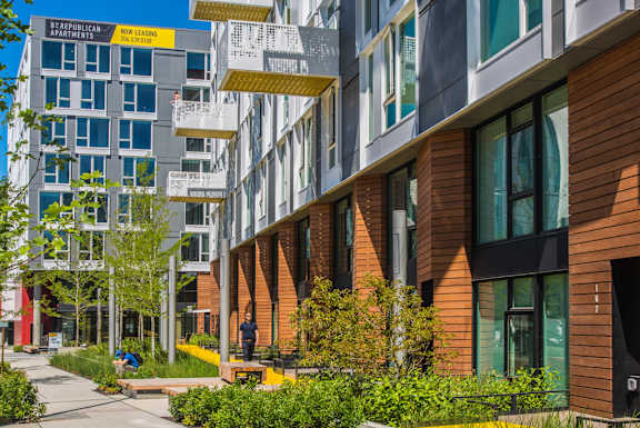 A modern apartment complex with a mix of brick and glass buildings.