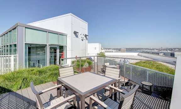 A modern building with a patio and a table.