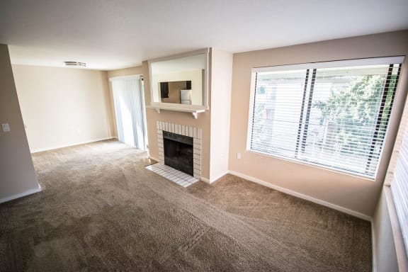 a living room with a fireplace and a large window