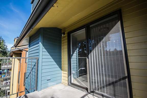 a sliding glass door opens to the patio of a house