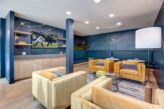 a living room with couches and chairs and a mural on the wall at Hazel Apartments, Edmonds, 98026