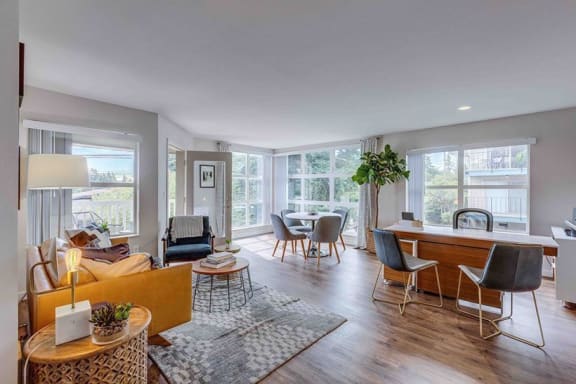 a living room and dining room with a table and chairs