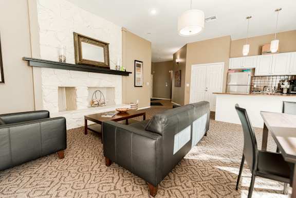 a living room with couches and a table and a fireplace