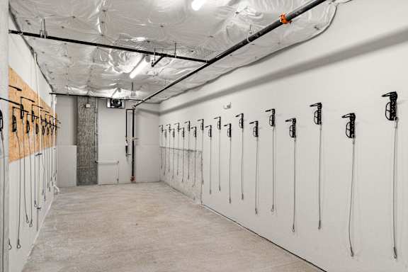 a row of white lockers in a room with inflated ceilings
