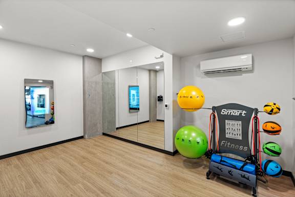 a workout room with a variety of weights and other exercise equipment