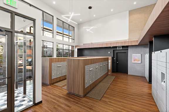 a view of the lobby of a building with wood floors and glass doors
