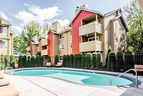 a swimming pool in front of some apartment buildings  at Cambridge on Seventh, Washington