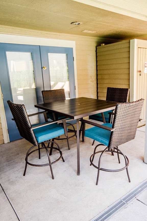 a patio with a wooden table and chairs at Cambridge on Seventh, Puyallup, WA